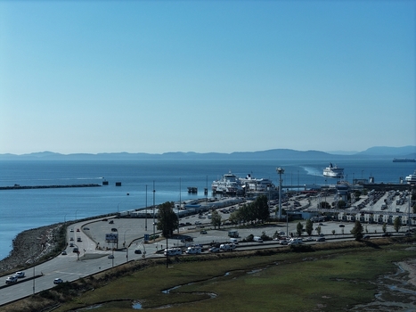 Aerial view of the BC Ferries Tsawwassen Terminal with ferry boats docked and arriving busy parking lots and coastal roads in Delta British Columbia Canada. Aerial view of the BC Ferries Tsawwassen Terminal with ferry boats docked and arriving busy parking lots and coastal roads in Delta British Columbia Canada.