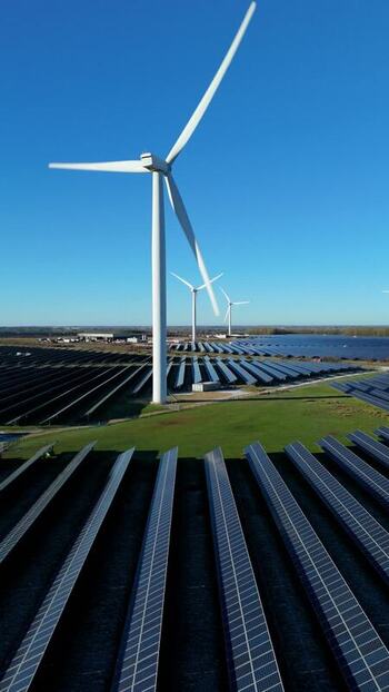 Aerial view of wind turbines and solar panels United Kingdom.