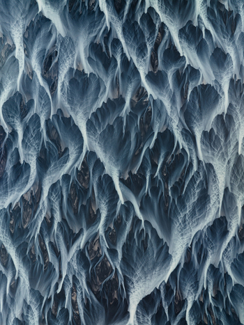 Aerial view of braided glacial rivers carving intricate patterns across the volcanic landscape Iceland Iceland. Aerial view of braided glacial rivers carving intricate patterns across the volcanic landscape Iceland Iceland.