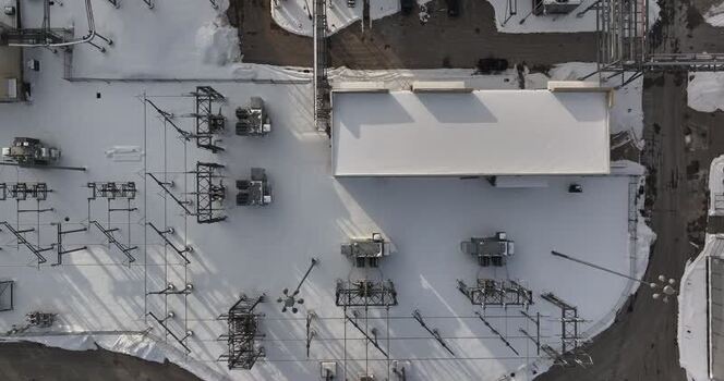 Aerial view of an electrical substation covered in snow United States. Aerial view of an electrical substation covered in snow United States.