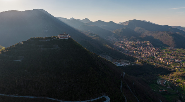 Aerial view of Santuario del Santissimo Salvatore on a mountain peak overlooking the valley and town of Montella surrounded by the Picentini mountains Montella Campania Italy. Aerial view of Santuario del Santissimo Salvatore on a mountain peak overlooking the valley and town of Montella surrounded by the Picentini mountains Montella Campania Italy.