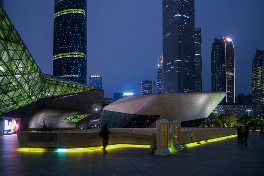 Guangzhou China 24 February 2024 View of the futuristic Guangzhou Opera House architecture illuminated at night with surrounding skyscrapers and modern urban plaza. Guangzhou China 24 February 2024 View of the futuristic Guangzhou Opera House architecture illuminated at night with surrounding skyscrapers and modern urban plaza.