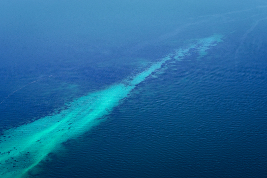 Aerial view of turquoise shallow water patterns contrasting with deep blue ocean in the Shire of Shark Bay Western Australia Australia. Aerial view of turquoise shallow water patterns contrasting with deep blue ocean in the Shire of Shark Bay Western Australia Australia.