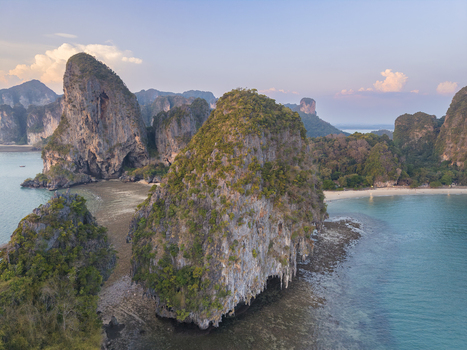 Aerial view of jagged limestone cliffs rise majestically from the turquoise waters a symphony of nature s artistry Krabi Thailand.