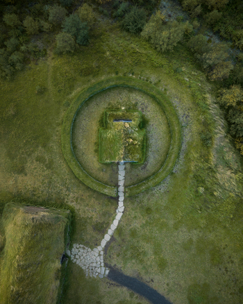 Aerial view of a grassy mound with concentric rings and a stone pathway leading to its peak standing as a testament to history Selfoss Skeiða og Gnúpverjahreppur Iceland. Aerial view of a grassy mound with concentric rings and a stone pathway leading to its peak standing as a testament to history Selfoss Skeiða og Gnúpverjahreppur Iceland.