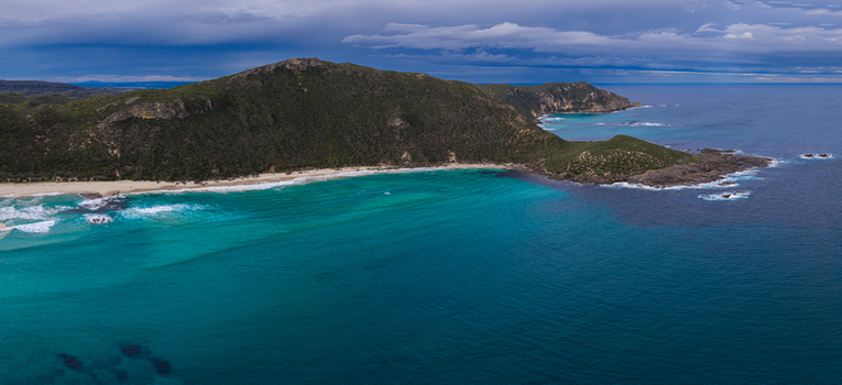 Aerial view of Conspicuous Cliff featuring rugged coastal cliffs turquoise waters and sandy beaches along the coastline in Nornalup Western Australia Australia. Aerial view of Conspicuous Cliff featuring rugged coastal cliffs turquoise waters and sandy beaches along the coastline in Nornalup Western Australia Australia.