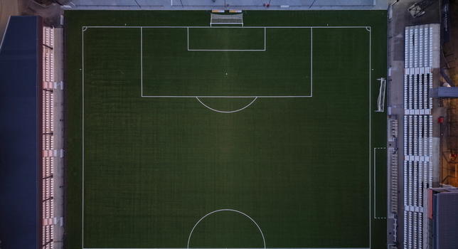Aerial view of Mladost Sports Center featuring a green soccer pitch with white markings and surrounding stadium seating in Pancevo Serbia. Aerial view of Mladost Sports Center featuring a green soccer pitch with white markings and surrounding stadium seating in Pancevo Serbia.