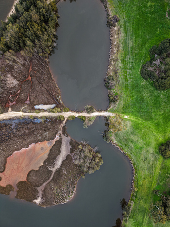Aerial view of Point Fraser featuring wetlands a winding river lush green grass and trees in East Perth Western Australia Australia.