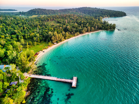 Aerial view of a pristine beach with turquoise waters meeting lush green forests revealing the serene beauty of the Cambodian coast Preah Sihanouk Sihanoukville Cambodia.