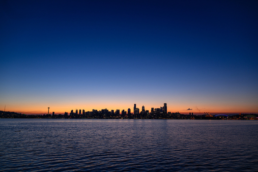 View of the Seattle skyline at twilight from Don Armeni Boat Ramp featuring the Space Needle and skyscrapers silhouetted against a sunset sky Seattle Washington United States. View of the Seattle skyline at twilight from Don Armeni Boat Ramp featuring the Space Needle and skyscrapers silhouetted against a sunset sky Seattle Washington United States.