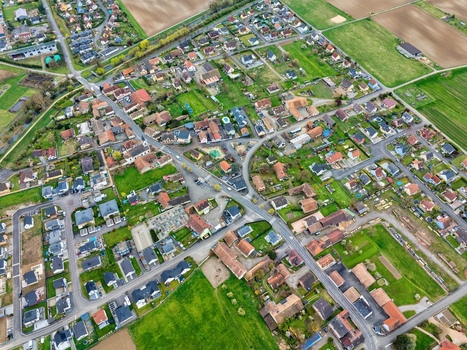 Aerial view of the quaint town unfolds with a tapestry of red roofed houses amidst verdant gardens and neatly arranged streets Neuf Brisach Grand Est France.