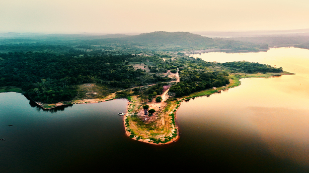 Aerial view of Owala Dam surrounded by lush green forests and calm reservoir waters during golden hour in Osogbo Osun Nigeria. Aerial view of Owala Dam surrounded by lush green forests and calm reservoir waters during golden hour in Osogbo Osun Nigeria.