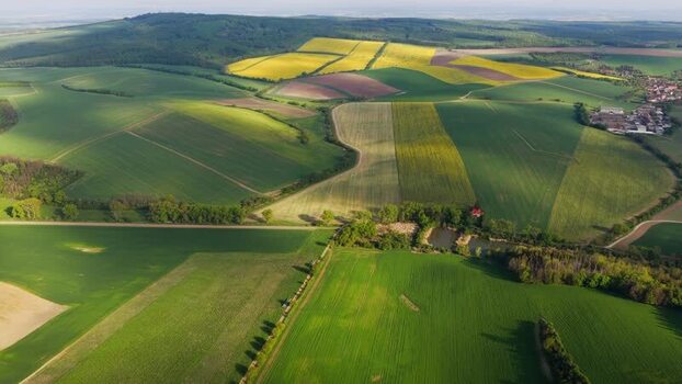 Aerial view of rolling green hills and fields in Czechia. Aerial view of rolling green hills and fields in Czechia.