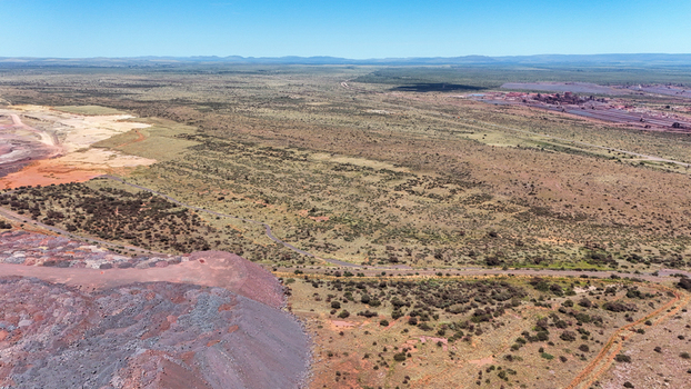 Aerial view of the stark contrast between the rust colored earth and the sparse vegetation under a clear sky North West Africa. Aerial view of the stark contrast between the rust colored earth and the sparse vegetation under a clear sky North West Africa.
