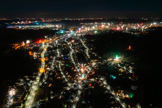 Aerial view of fireworks exploding over the illuminated town at night with glowing streets and residential houses Forchheim Bavaria Germany. Aerial view of fireworks exploding over the illuminated town at night with glowing streets and residential houses Forchheim Bavaria Germany.