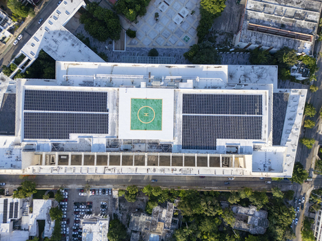 Aerial view of the Centro Internacional de Congresos de Yucatan featuring rooftop solar panels and a helipad in the urban landscape of Merida Yucatan Mexico. Aerial view of the Centro Internacional de Congresos de Yucatan featuring rooftop solar panels and a helipad in the urban landscape of Merida Yucatan Mexico.