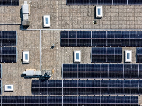 Aerial view of solar panels installed on a flat rooftop with skylights in Lisboa Lisboa Portugal.