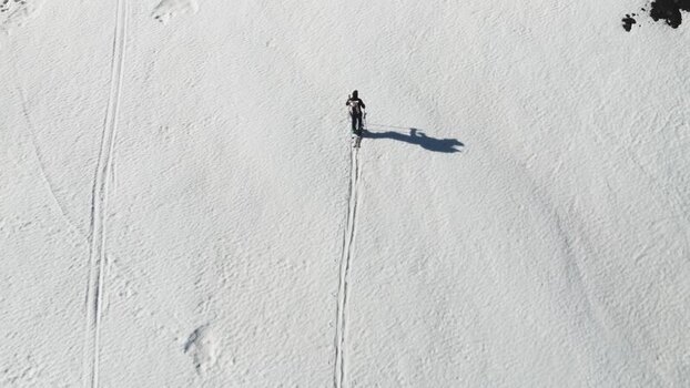 Aerial view of a person ski touring on snow near Rifugio Sapienza Italy. Aerial view of a person ski touring on snow near Rifugio Sapienza Italy.