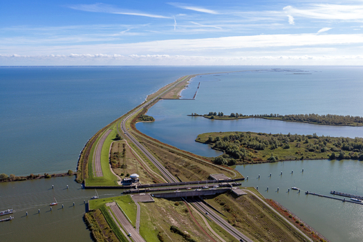 Aerial view of Naviduct Krabbersgat a unique water bridge where the road passes beneath the canal surrounded by water and dikes in Lelystad Flevoland Netherlands. Aerial view of Naviduct Krabbersgat a unique water bridge where the road passes beneath the canal surrounded by water and dikes in Lelystad Flevoland Netherlands.