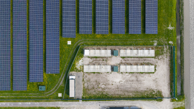 Aerial view of battery storage and mobile container charging at De Dijken Solar Park near Warmenhuizen supporting grid balance renewable energy and flexible power use. Aerial view of battery storage and mobile container charging at De Dijken Solar Park near Warmenhuizen supporting grid balance renewable energy and flexible power use.