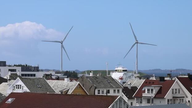 Aerial view of rooftops and wind turbines in Haugesund Norway.