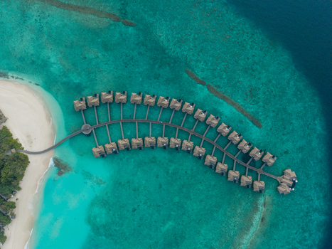 Aerial view of overwater bungalows on turquoise water white sand and green island Hoarafushi Thiladhunmathee Uthuruburi Maldives. Aerial view of overwater bungalows on turquoise water white sand and green island Hoarafushi Thiladhunmathee Uthuruburi Maldives.