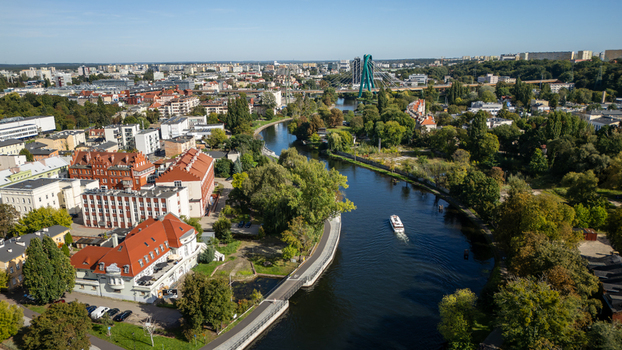 Aerial view of the Brda River meandering through a vibrant urban landscape highlighted by the distinctive green arches of a bridge Bydgoszcz Województwo kujawsko pomorskie Poland. Aerial view of the Brda River meandering through a vibrant urban landscape highlighted by the distinctive green arches of a bridge Bydgoszcz Województwo kujawsko pomorskie Poland.
