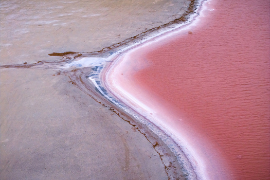 Aerial view of where the pink and beige waters meet creating a stark contrast of colors and textures in the landscape Salt lake city Utah United States. Aerial view of where the pink and beige waters meet creating a stark contrast of colors and textures in the landscape Salt lake city Utah United States.