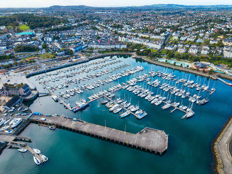 Aerial view of Bangor Harbour and Town with numerous sailboats docked in the marina surrounded by urban buildings and coastal landscape in Bangor Northern Ireland United Kingdom.