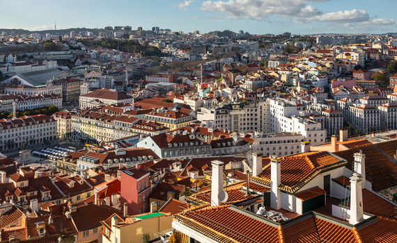 Aerial view of the historic city of Lisbon featuring dense terracotta rooftops traditional architecture and urban streets in Lisbon Lisbon Portugal.