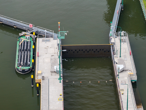 Aerial view of the Spandau Lock with a barge moored alongside the concrete walls and navigation markers in the Havel river in Berlin Berlin Germany.