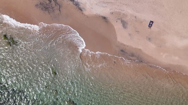 Aerial view of a sandy beach and a person sunbathing Portugal. Aerial view of a sandy beach and a person sunbathing Portugal.