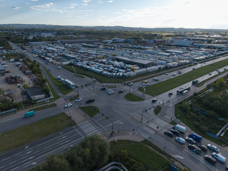 Krakow Poland 16 September 2026 Aerial view of Rybitwy Market with its extensive parking area filled with delivery trucks adjacent to a busy road intersection. Krakow Poland 16 September 2026 Aerial view of Rybitwy Market with its extensive parking area filled with delivery trucks adjacent to a busy road intersection.