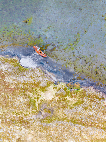 Aerial view of a rusted shipwreck beached on the rocky coastline of Iceland. Aerial view of a rusted shipwreck beached on the rocky coastline of Iceland.