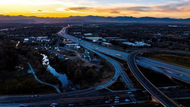 Aerial view of highway interchange at sunset in United States.