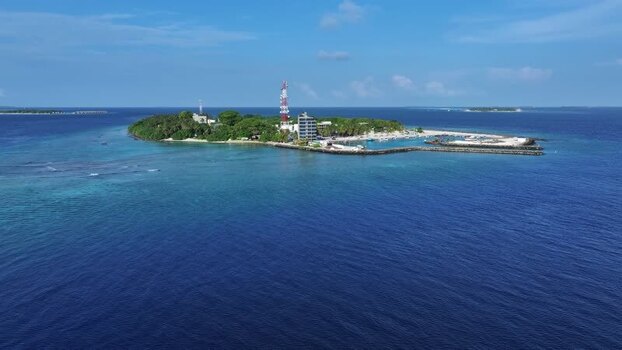 Aerial view of Kamadhoo island with lush greenery and harbor Maldives. Aerial view of Kamadhoo island with lush greenery and harbor Maldives.
