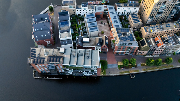 Aerial view of modern residential buildings with solar panels on rooftops situated along the waterfront in Zwolle Overijssel Netherlands.