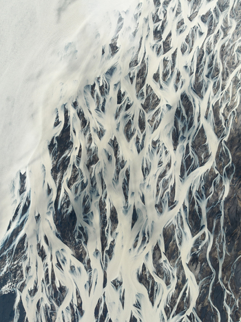 Aerial view of glacial rivers cutting through the dark earth a stark contrast between the icy water and the rugged terrain Iceland Iceland. Aerial view of glacial rivers cutting through the dark earth a stark contrast between the icy water and the rugged terrain Iceland Iceland.