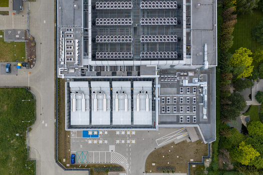 Aerial view of an AI data center featuring complex cooling systems industrial fans and ventilation infrastructure in Warsaw Masovian Voivodeship Poland. Aerial view of an AI data center featuring complex cooling systems industrial fans and ventilation infrastructure in Warsaw Masovian Voivodeship Poland.