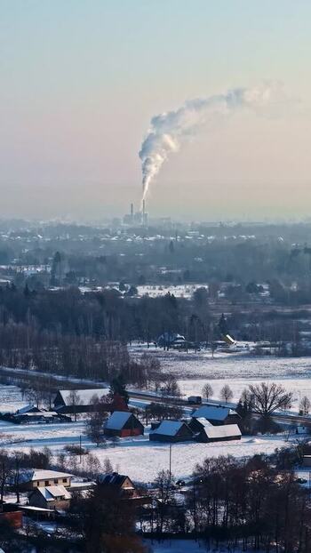 Aerial view of snowy landscape and factory Latvia.