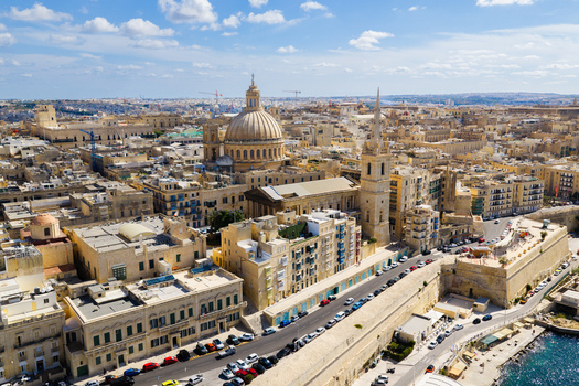 Aerial view of the Basilica of Our Lady of Mount Carmel and St. Pauls Pro Cathedral surrounded by historic limestone buildings in Valletta Regjun Port Malta. Aerial view of the Basilica of Our Lady of Mount Carmel and St. Pauls Pro Cathedral surrounded by historic limestone buildings in Valletta Regjun Port Malta.