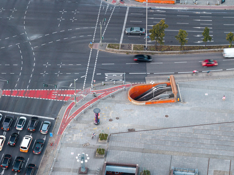 Aerial view of a busy urban intersection with a subway entrance bike lanes and traffic in Berlin Berlin Germany. Aerial view of a busy urban intersection with a subway entrance bike lanes and traffic in Berlin Berlin Germany.