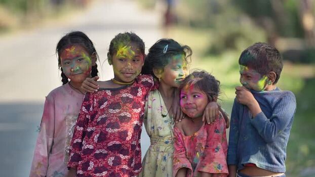 View of children with colorful powder on their faces in Dang Nepal.
