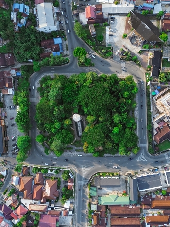 Aerial view of Taman Samarendah surrounded by lush green trees urban roads and residential rooftops in Samarinda East Kalimantan Indonesia. Aerial view of Taman Samarendah surrounded by lush green trees urban roads and residential rooftops in Samarinda East Kalimantan Indonesia.