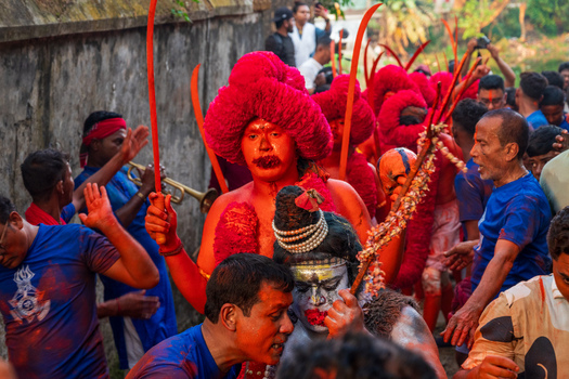 Munshiganj Bangladesh 13 April 2026 View of devotees participating in a traditional Hindu festival with red body paint and elaborate costumes.