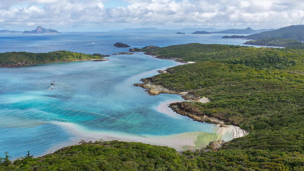 Aerial view of Chance Bay with turquoise waters white sandy beaches and lush green vegetation on the islands in the Whitsundays Queensland Australia. Aerial view of Chance Bay with turquoise waters white sandy beaches and lush green vegetation on the islands in the Whitsundays Queensland Australia.