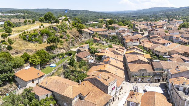Aerial view of the historic town with traditional stone houses terracotta rooftops and surrounding green hills in Allariz Province of Ourense Spain. Aerial view of the historic town with traditional stone houses terracotta rooftops and surrounding green hills in Allariz Province of Ourense Spain.