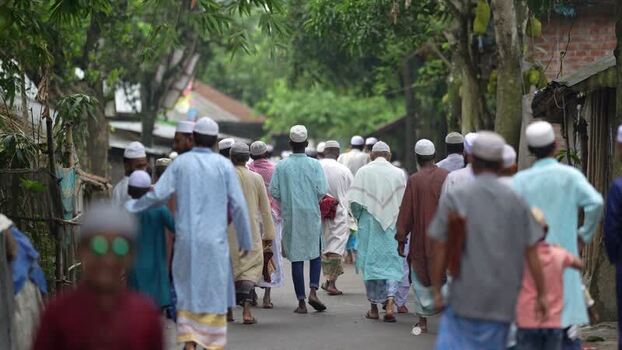 View of men in traditional attire walking in Bogura Bangladesh. View of men in traditional attire walking in Bogura Bangladesh.