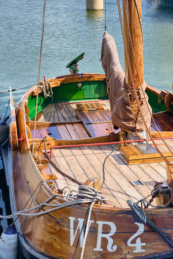Den Oever Netherlands 18 May 2026 View of the wooden deck of a historic Wieringeraak sailing vessel with polished timber ropes and a tall mast in the fishing harbor. Den Oever Netherlands 18 May 2026 View of the wooden deck of a historic Wieringeraak sailing vessel with polished timber ropes and a tall mast in the fishing harbor.