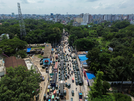 Rajshahi Bangladesh 26 September 2026 Aerial view of heavy traffic on a city street surrounded by lush green trees and urban buildings in Rajshahi. Rajshahi Bangladesh 26 September 2026 Aerial view of heavy traffic on a city street surrounded by lush green trees and urban buildings in Rajshahi.